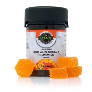 Orange-flavored CBD and Delta 8 gummies in a black jar.